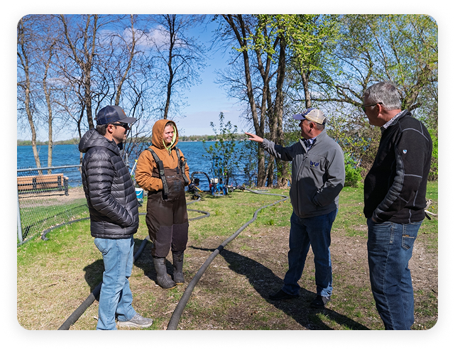 People talking by a lake