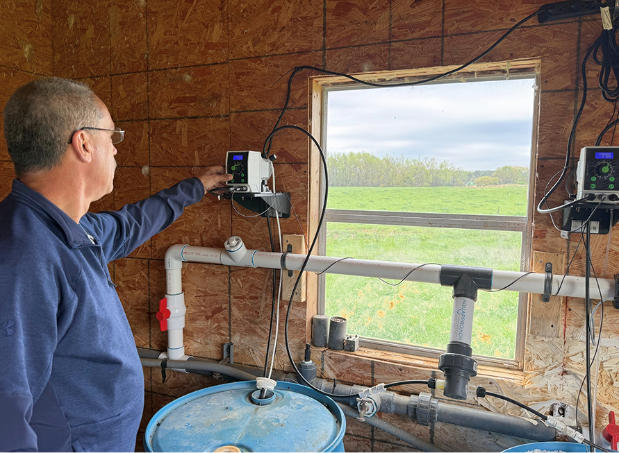 C&S employee inspecting a poultry water system